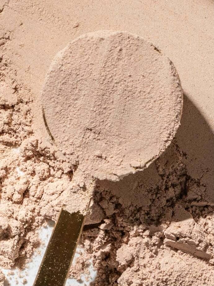 Close-up of the Free Soul powder with a full scoop pressed into it, the grain of the powder visible