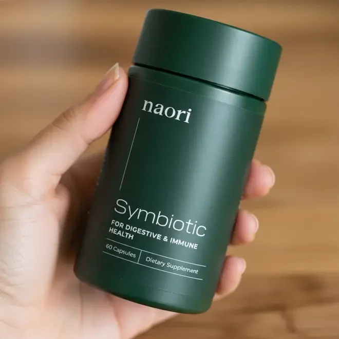 Naori Symbiotic jar of probiotic capsules, held in a hand, from the seller's product photography