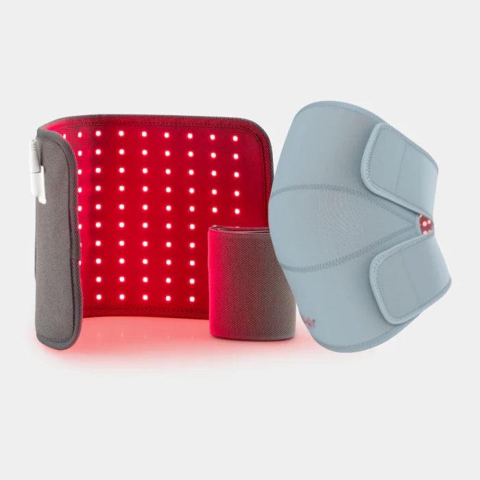 The lit Light Pad photographed beside the unlit grey Novaa Knee Ultra wrap and a rolled strap, on a plain background