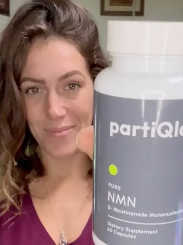Woman holding a PartiQlar Pure NMN bottle up to the camera, from the brand's marketing creatives