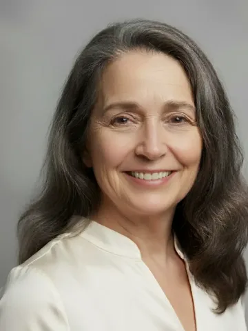 Smiling woman in a cream blouse, from partiQlar's marketing creatives