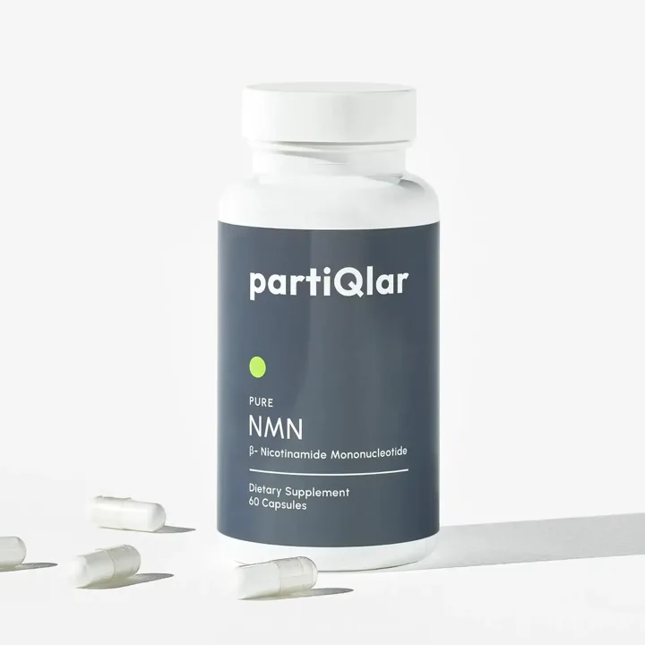PartiQlar Pure NMN bottle with 60 capsules, several white capsules lying beside it