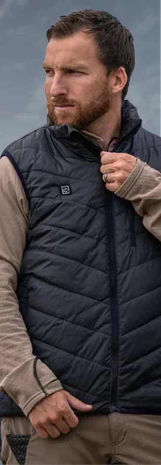 Man wearing the WellaHeat Heated Vest, control button visible on the chest, from the seller's product photos