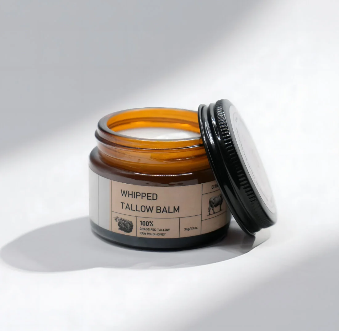 seller's packshot of the tallow balm jar, label listing 100% grass-fed tallow and raw wild honey